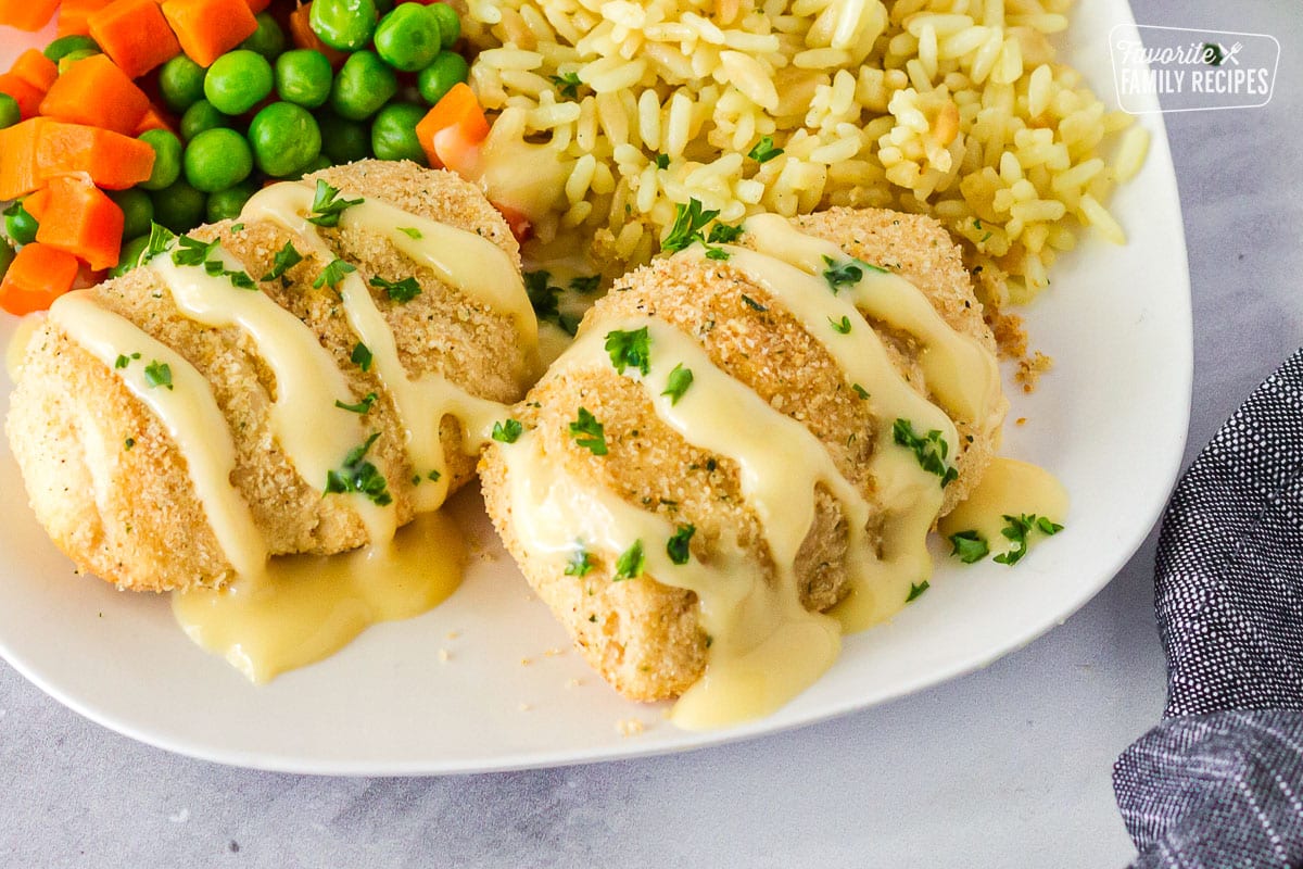 Plate of Chicken Roll Ups with rice and vegetables.