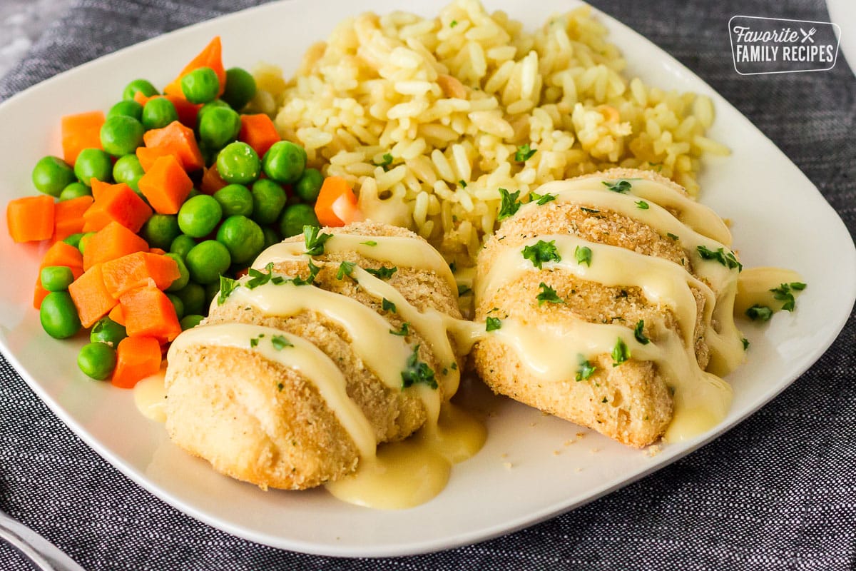 Plate of Chicken Roll Ups with rice and vegetables.