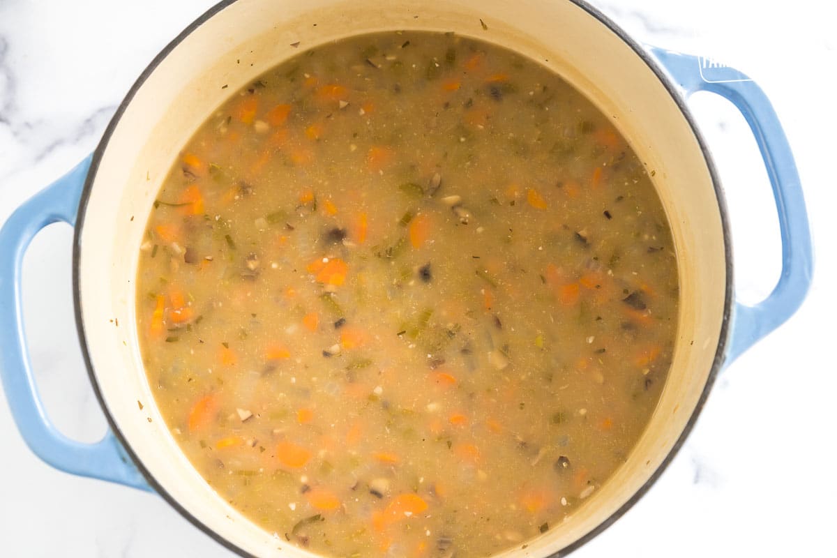 broth, veggies, and grains cooking in a large pot