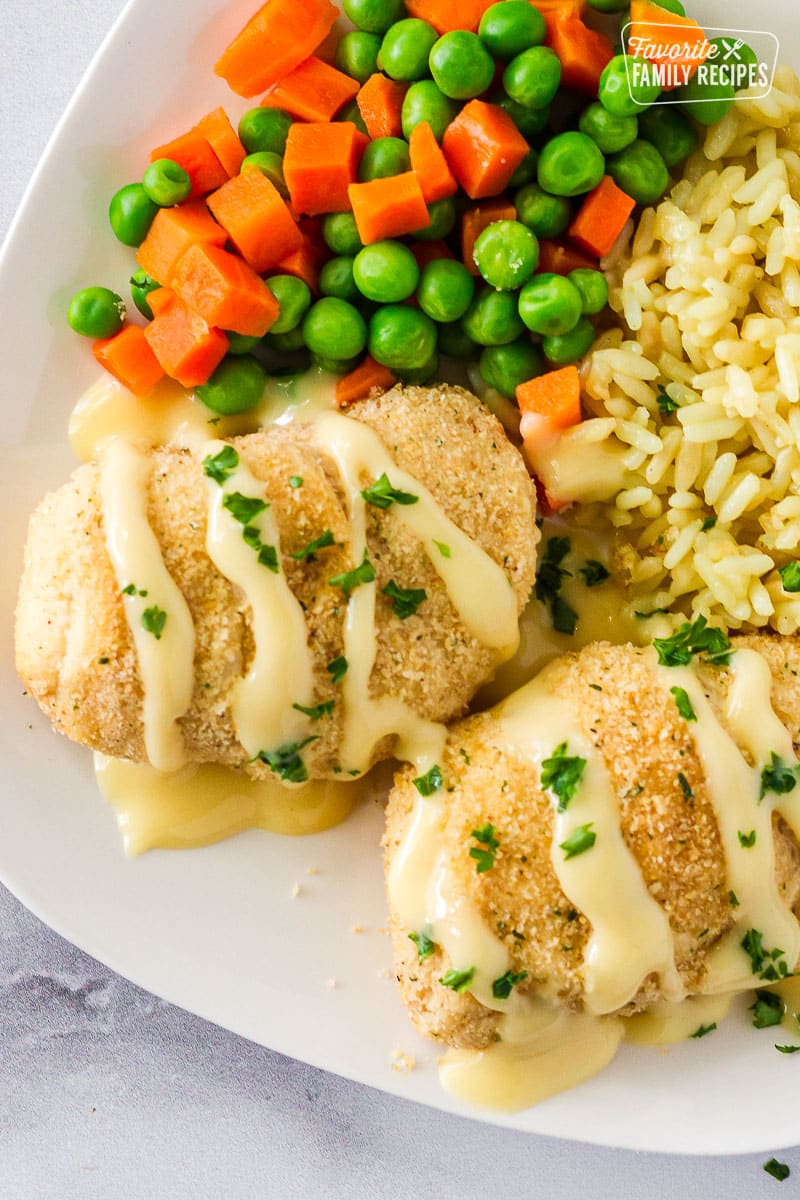 Plate of Chicken Roll Ups with rice and vegetables.