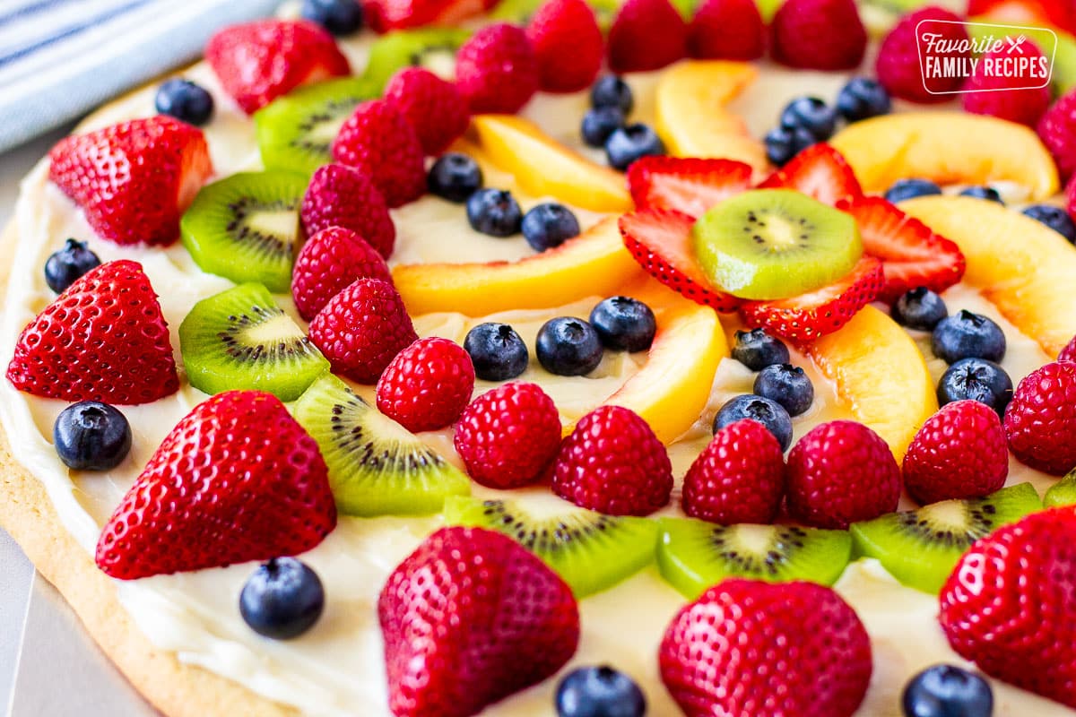 Top of Fruit Pizza with strawberries, blueberries, kiwis, peaches and raspberries.