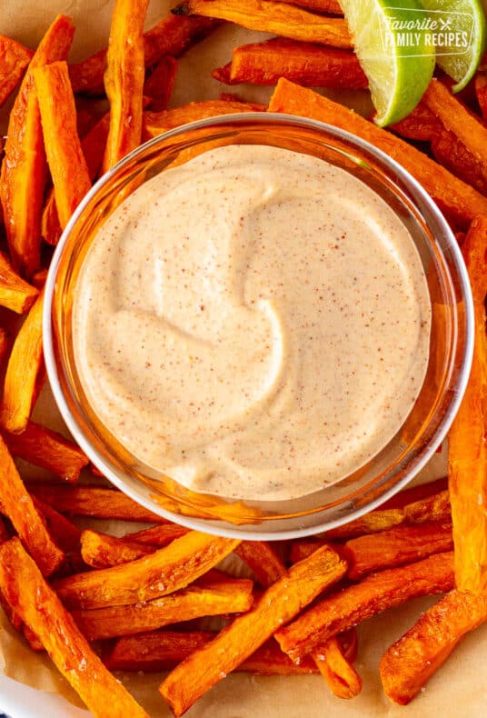 Plate of Dipping sauce surrounded by sweet potato fries.