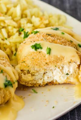 Cut piece of Chicken Roll up with a fork resting on a plate. Rice on the side.