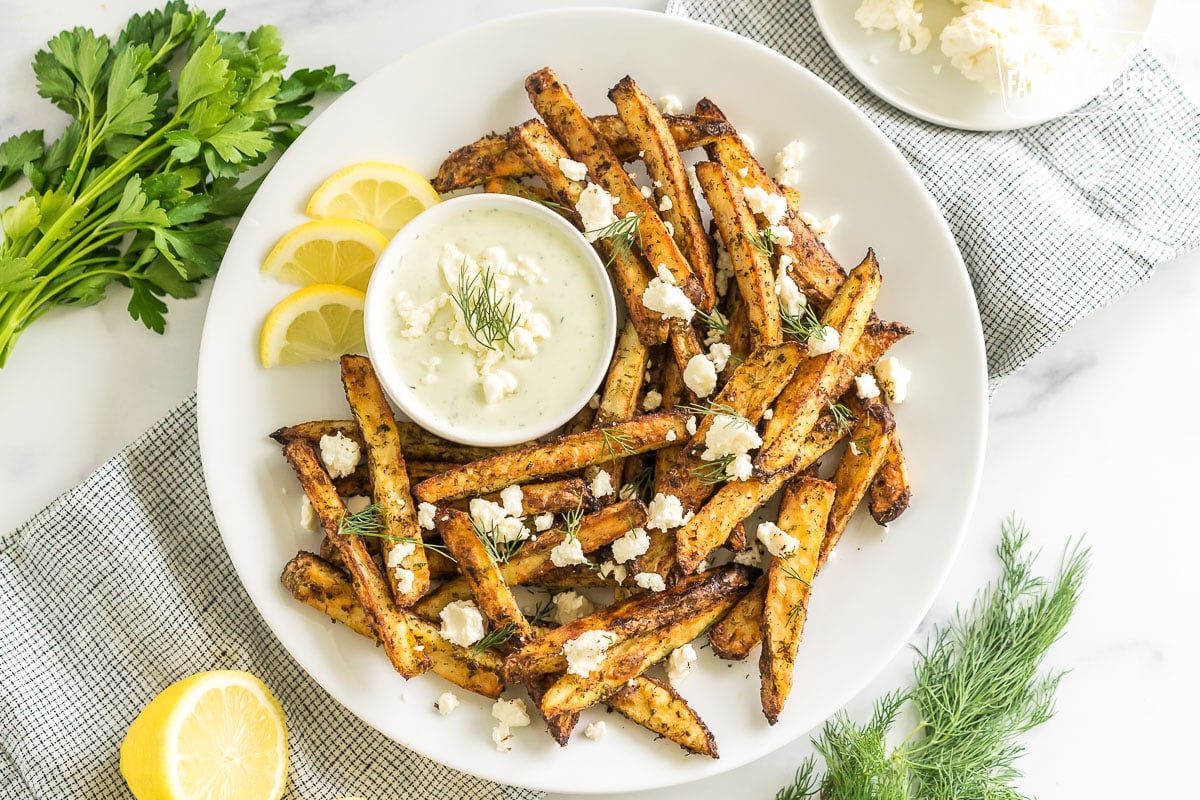 Greek Fries with feta dip on a plate