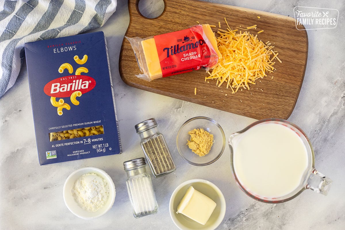 Ingredients to make Homemade Mac and Cheese including shredded cheese, elbow macaroni, milk, dry mustard, butter, salt, pepper and corn starch.