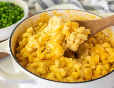 Wooden spoon with Homemade Mac and cheese.