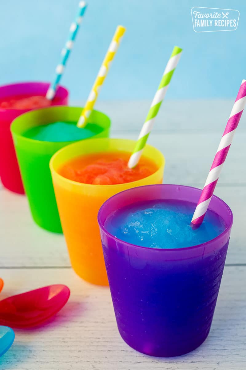 Blue and pink slushie in cups with colorful straws.