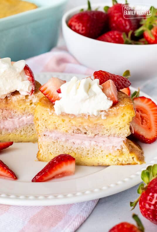 Cut in half slice of Strawberry French Toast on a plate.