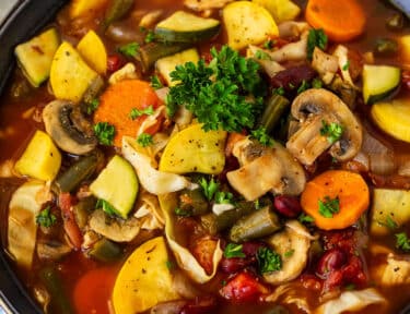 Bowl of Weight Loss Magic Soup garnished with parsley.