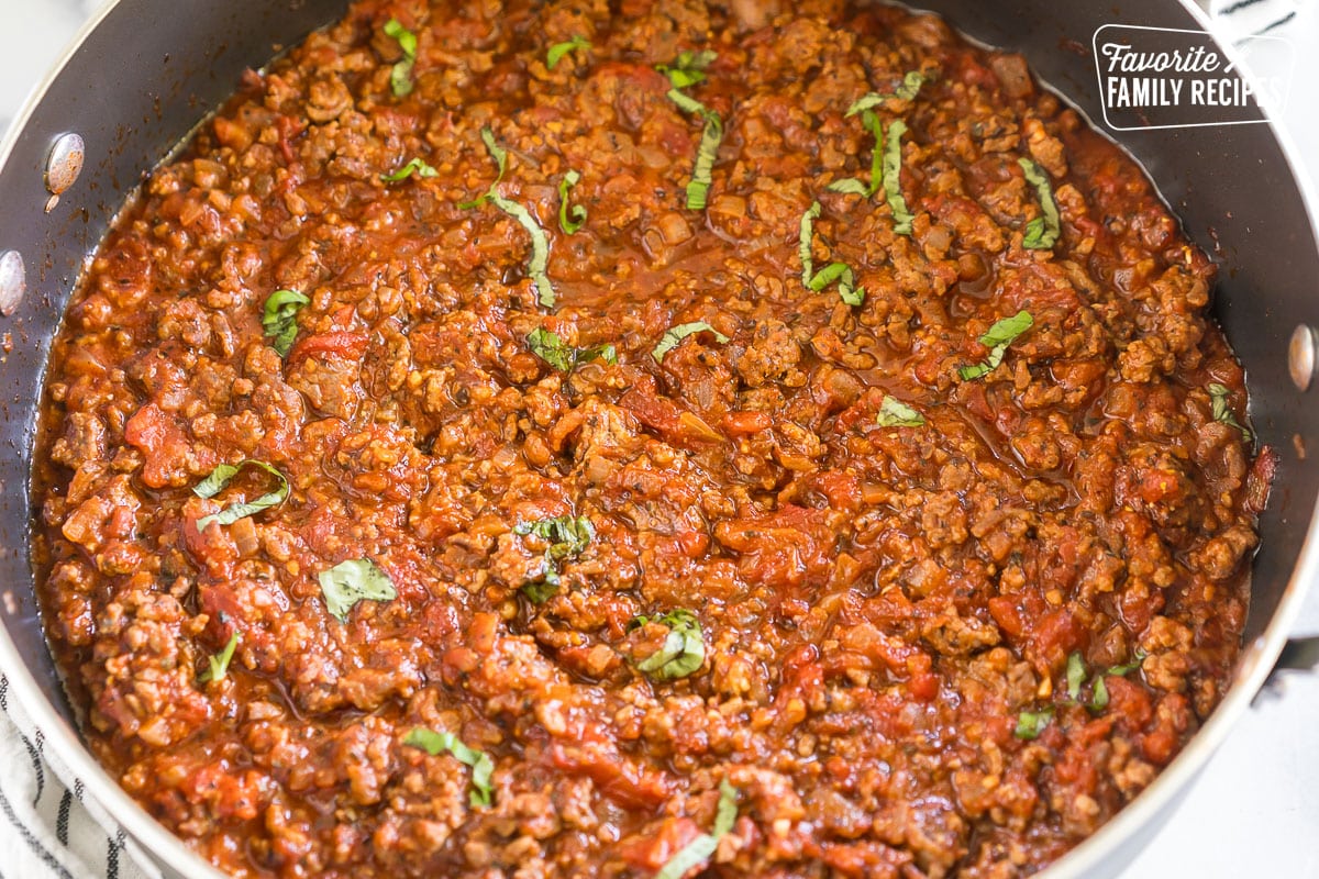 Meat Sauce in a skillet topped with basil