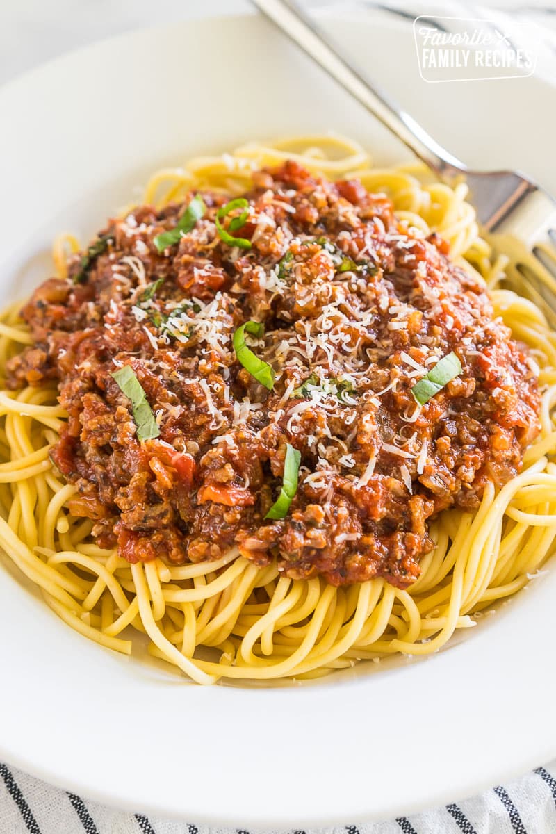 Meat Sauce on pasta topped with parmesan and basil