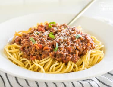 Meat Sauce on pasta topped with parmesan and basil