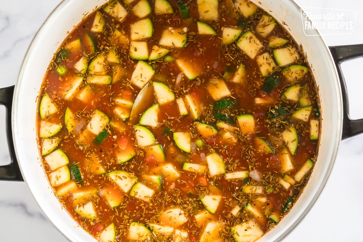 Broth, veggies and spices simmering in a pot