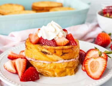 Strawberry French Toast topped with strawberries and whipped cream.