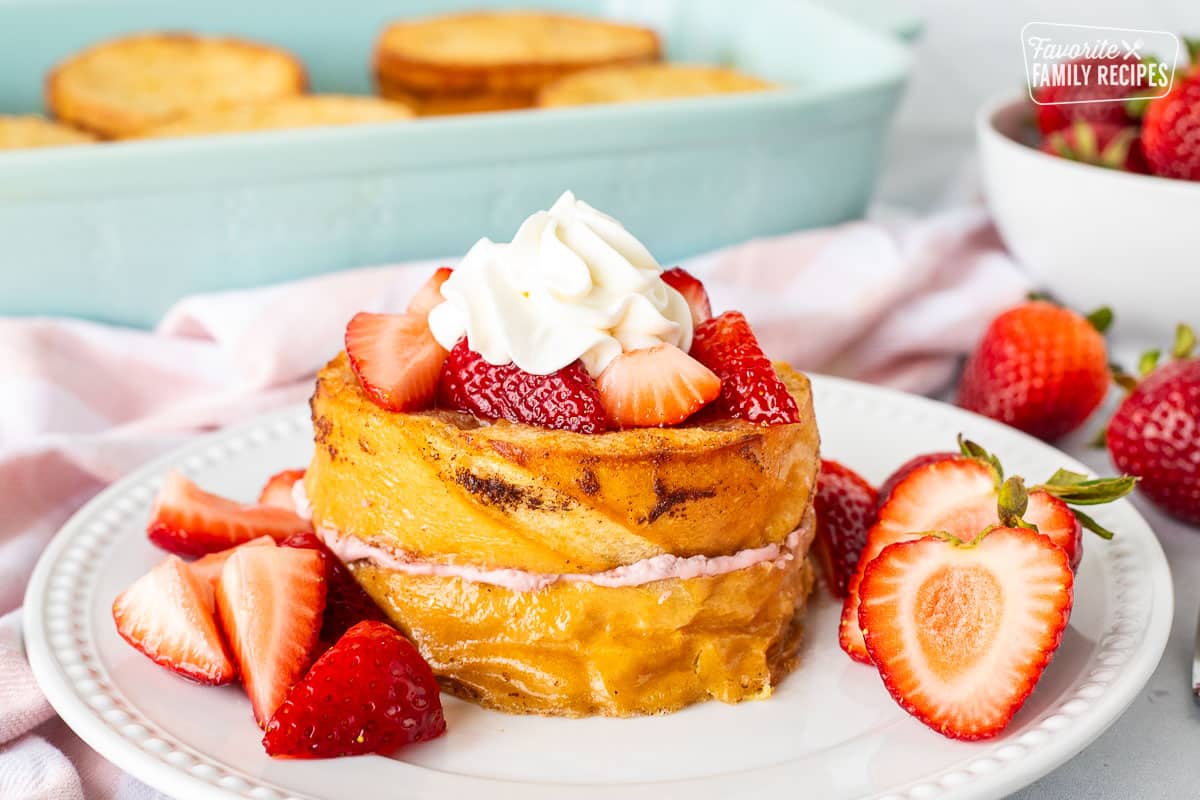 Strawberry French Toast topped with strawberries and whipped cream.