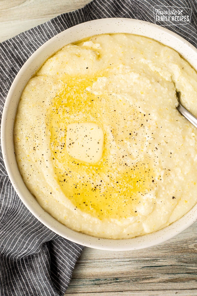 Spoon in a bowl of Grits with melted butter.