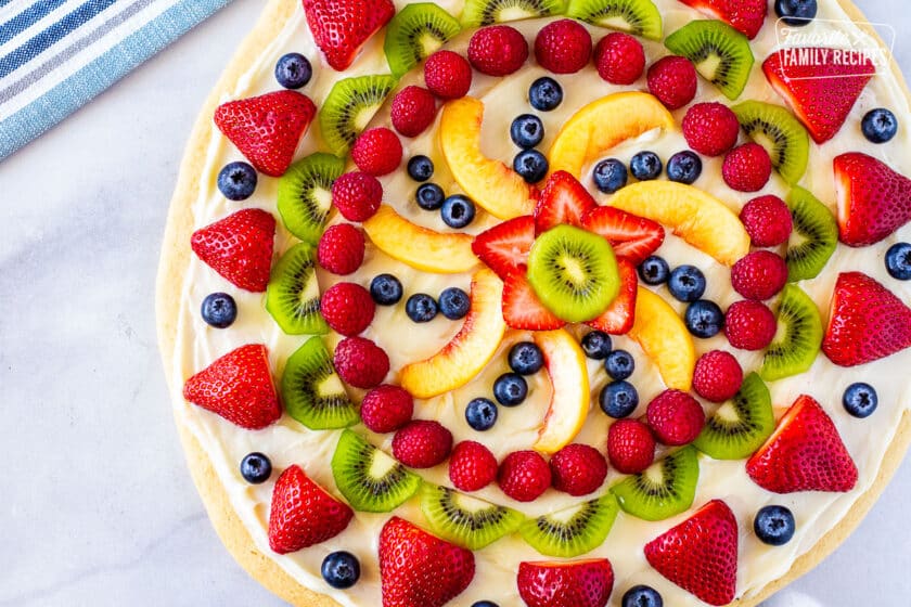 Whole easy fruit pizza with a colorful array of fresh fruit on top.