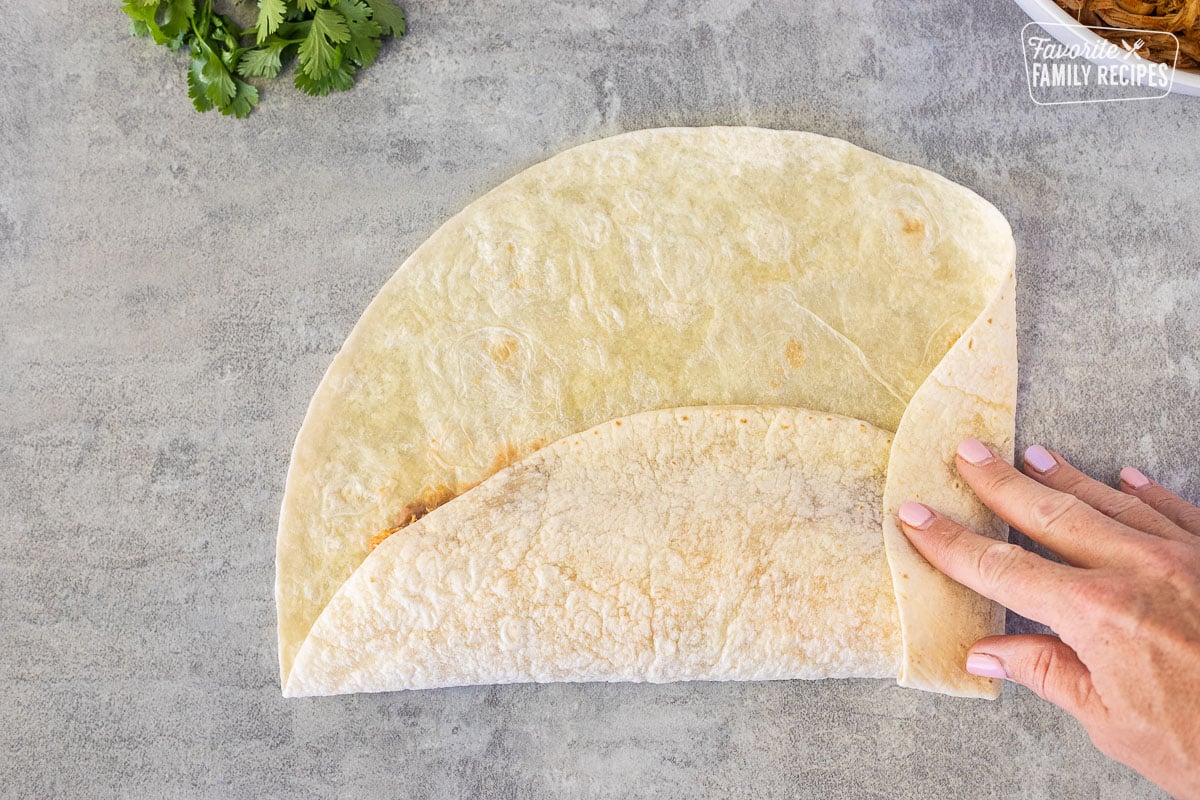 Folding a flour tortilla.