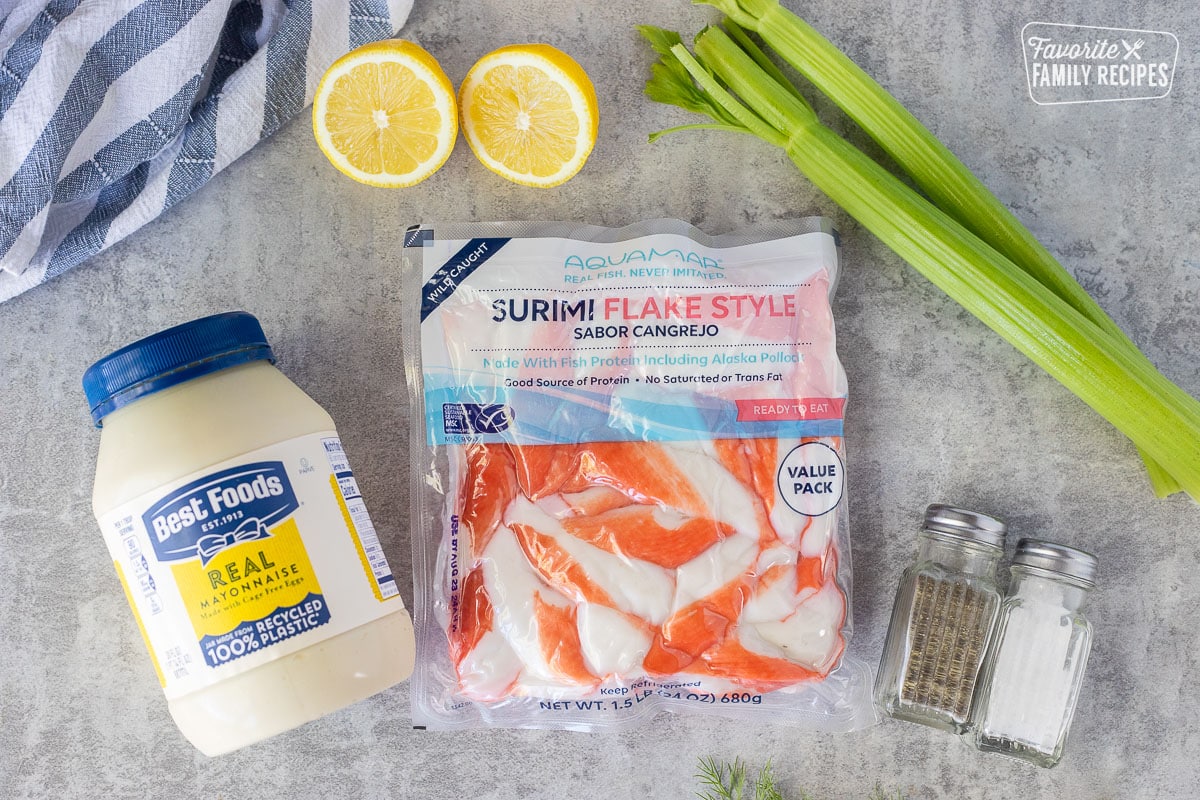 Ingredients to make Cold Crab Dip Recipe including celery, crab, mayonnaise, salt, pepper and lemon.