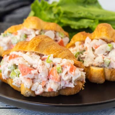 Three Crab Salad Sandwiches on a plate.