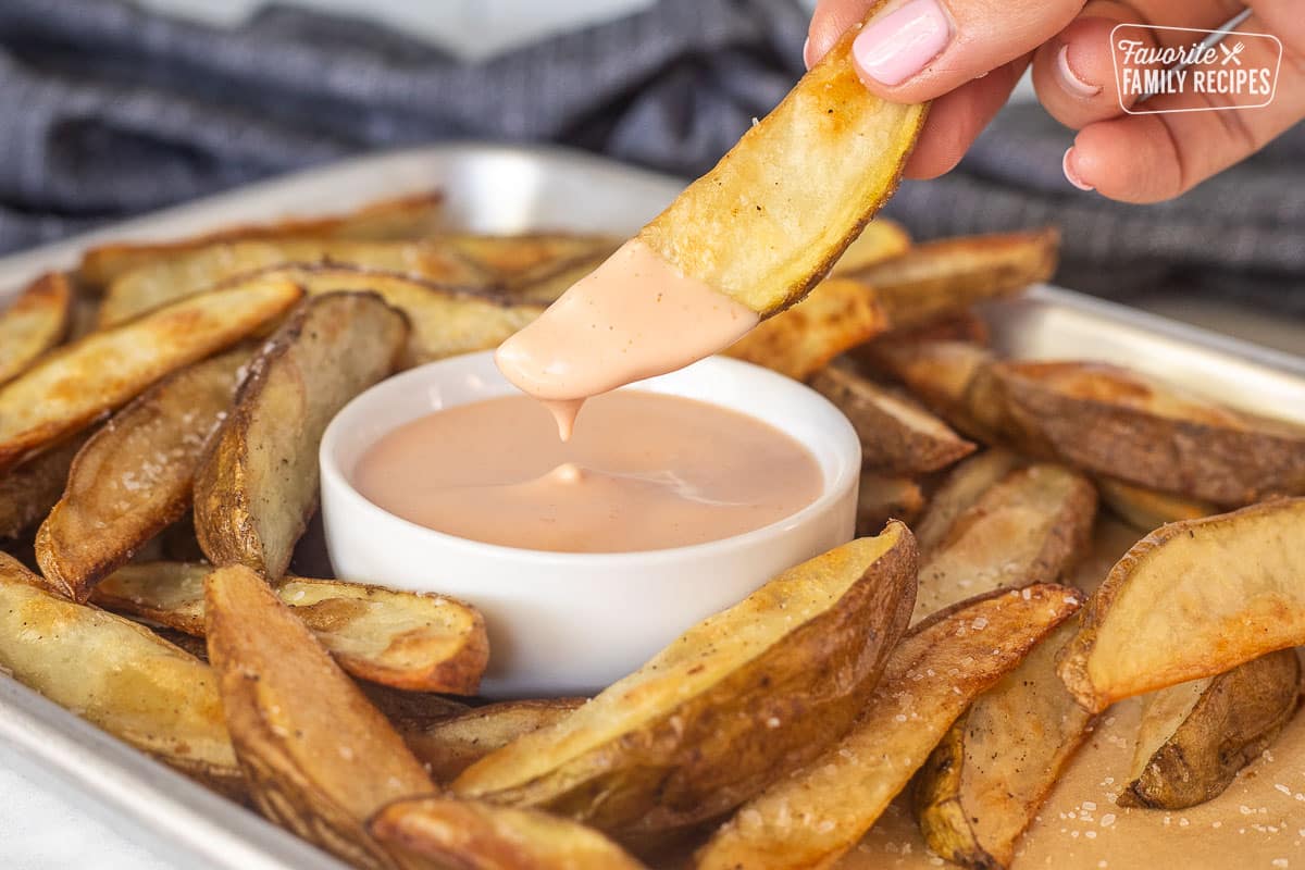Dipping a potato fry in Fry Sauce.
