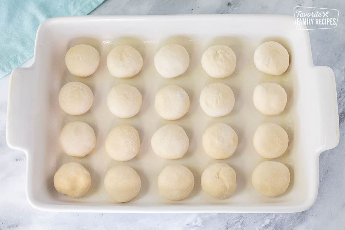 Frozen rolls in a baking dish for preparing Pani Popo.