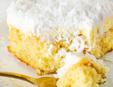 Slice of Hawaiian Wedding Cake on a plate with a fork.