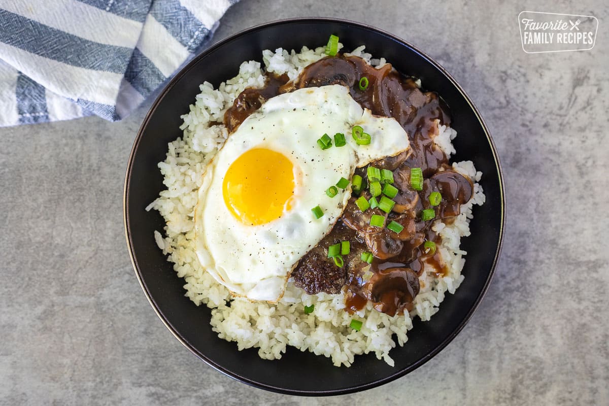 Loco Moco in a bowl garnished with green onion.