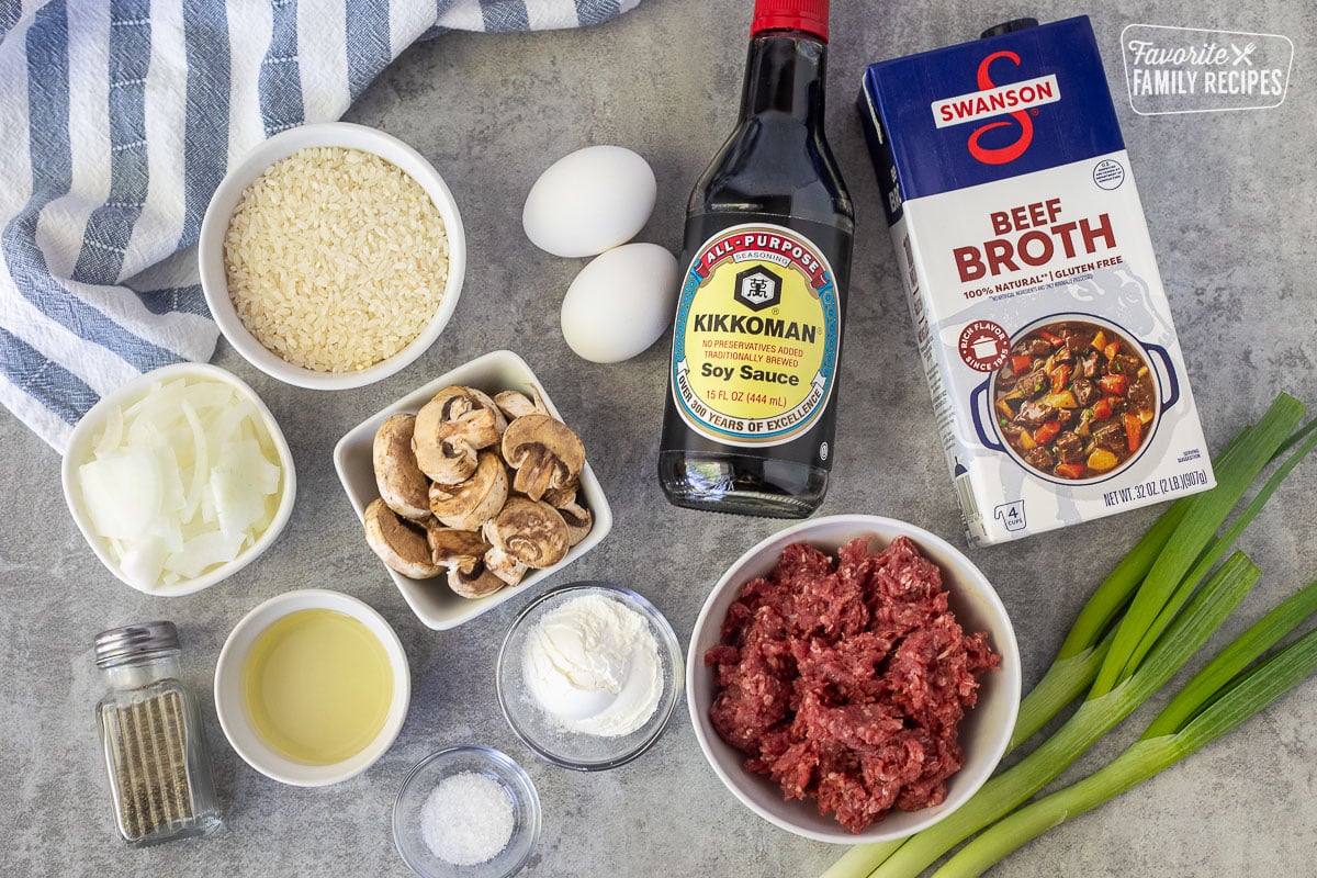 Ingredients to make Loco Moco including eggs, soy sauce, beef broth, ground beef, green onions, corn starch, salt, pepper, oil, onion, mushrooms and rice.