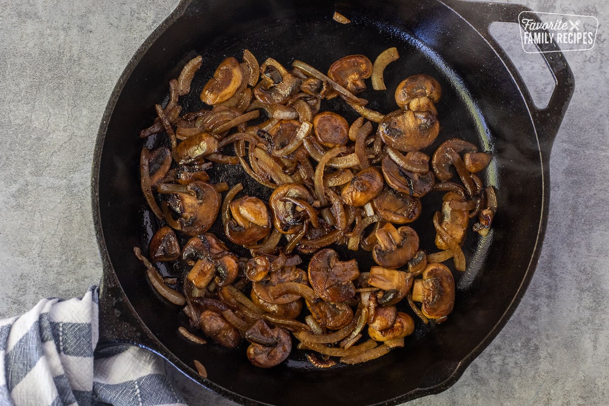 Skillet with sautéed onions and mushrooms.