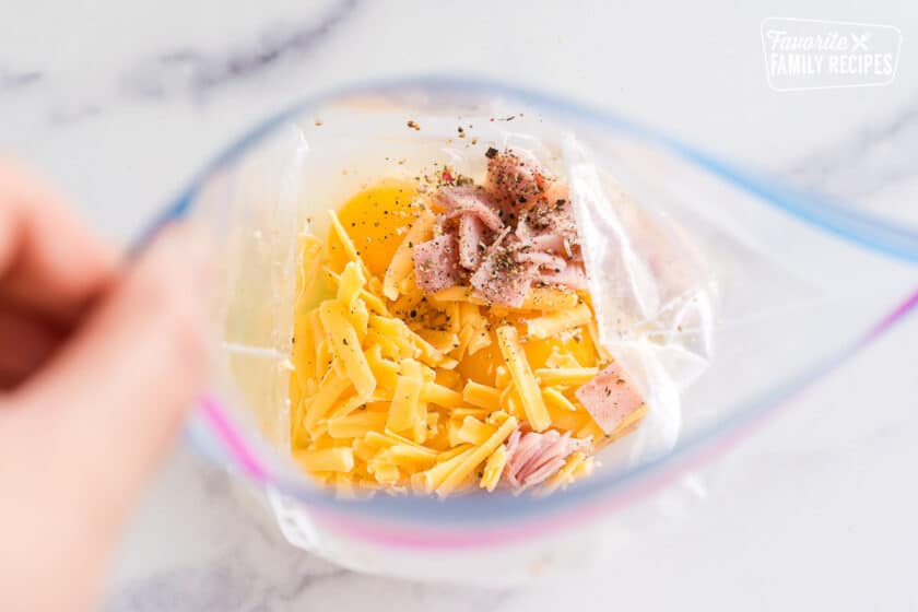 eggs, ham, cheese and seasoning in a ziplock bag to make an omelette in a bag