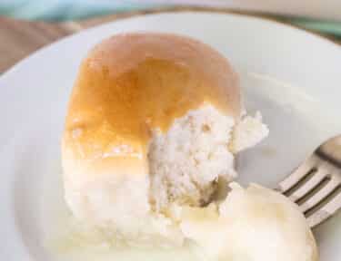 Fork holding a bite of Pani Popo on a plate.