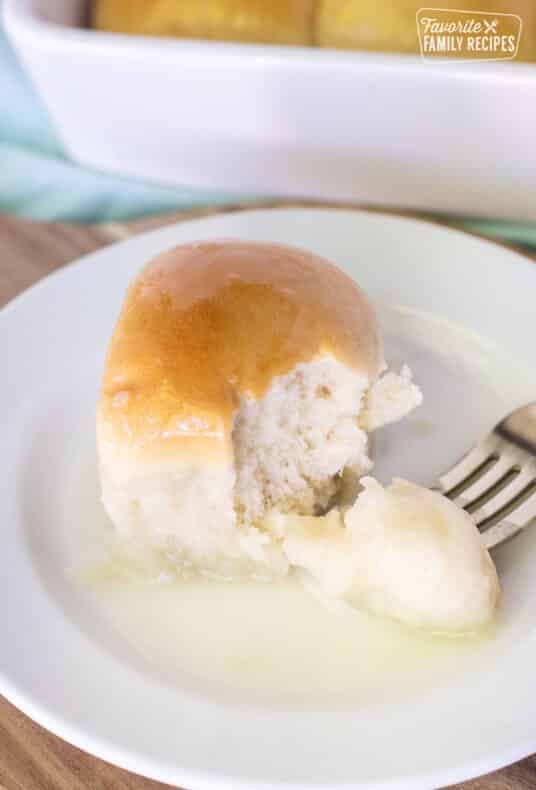 Fork holding a bite of Pani Popo on a plate.