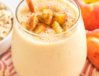 Peaches and Cream Oatmeal Smoothie in a cup with a straw