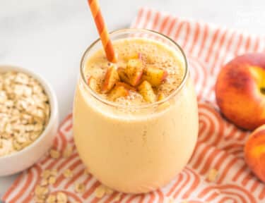 Peaches and Cream Oatmeal Smoothie in a cup with a straw