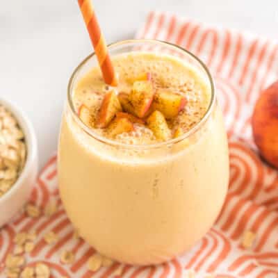 Peaches and Cream Oatmeal Smoothie in a cup with a straw