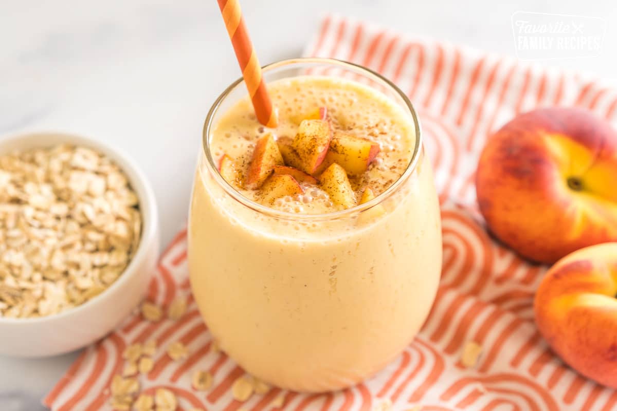 Peaches and Cream Oatmeal Smoothie in a cup with a straw