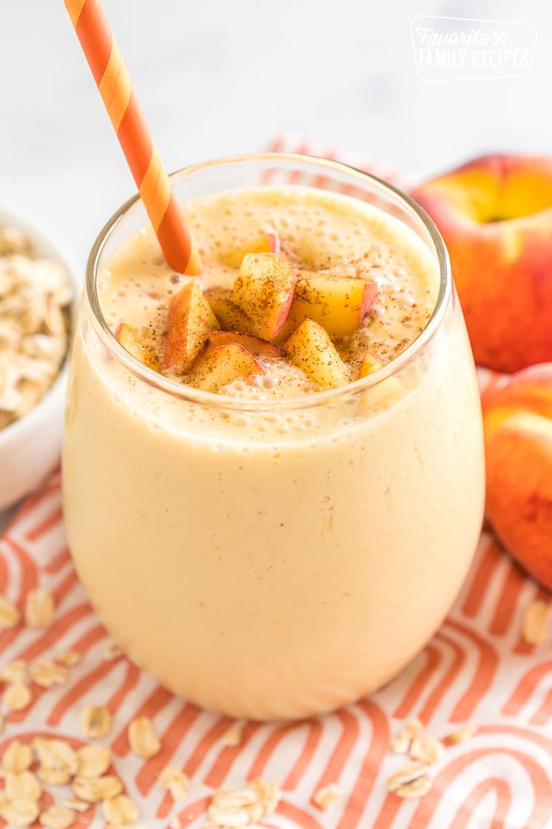 Peaches and Cream Oatmeal Smoothie in a cup with a straw