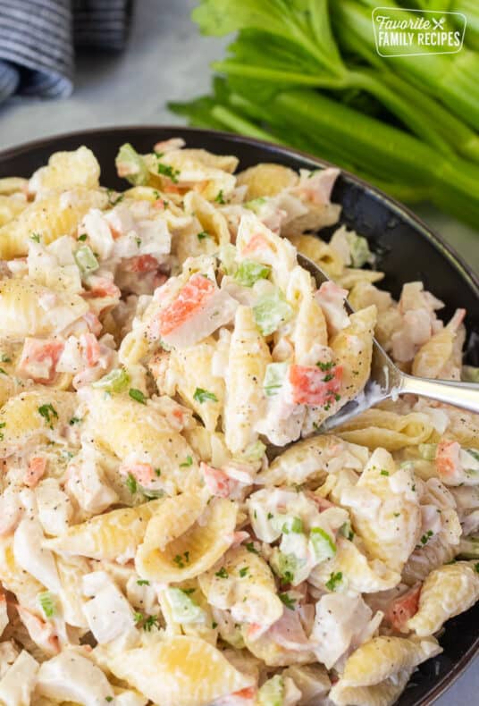 Spoon scooping Crab Pasta Salad out of a bowl.