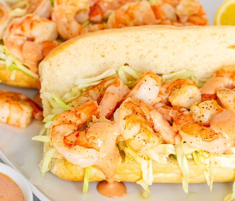 Two Shrimp Po'Boy Sandwiches on a plate.