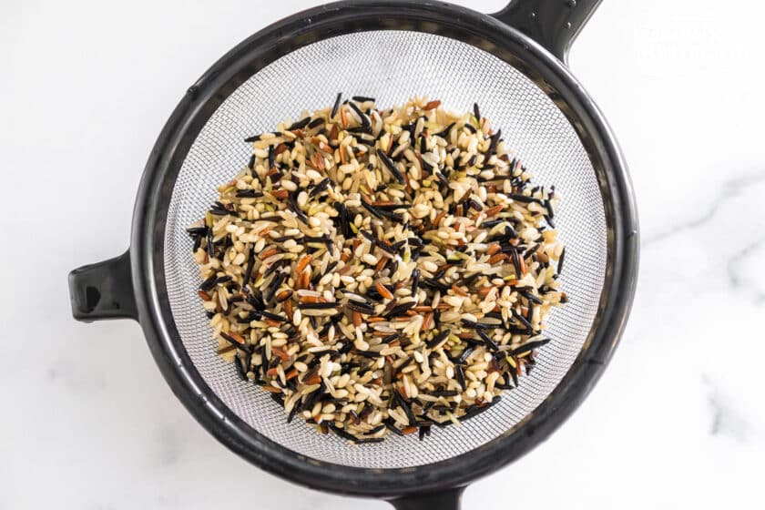 rinsed and drained wild rice in a strainer