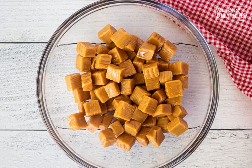 Glass bowl with unwrapped caramels.