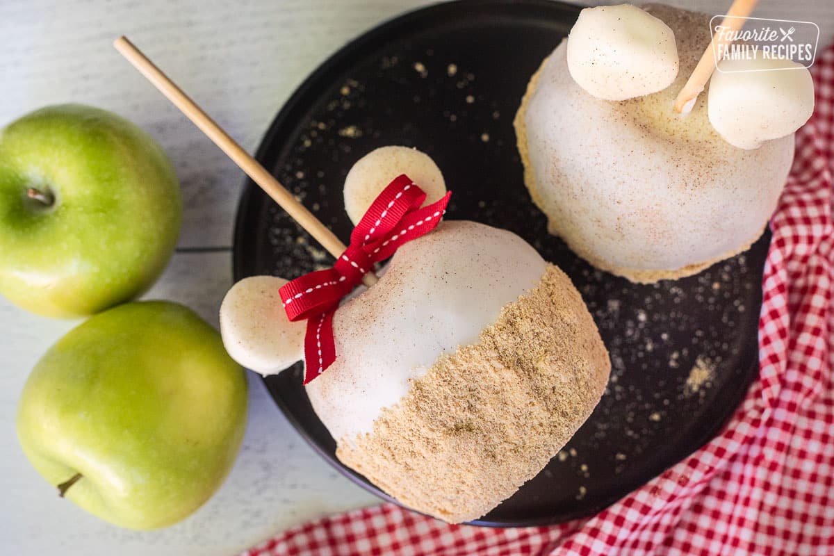 Apple Pie Caramel Apple with bow and two mouse ears on a plate.