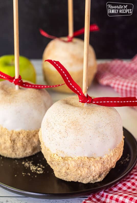 Two Apple Pie Caramel Apples on a plate.