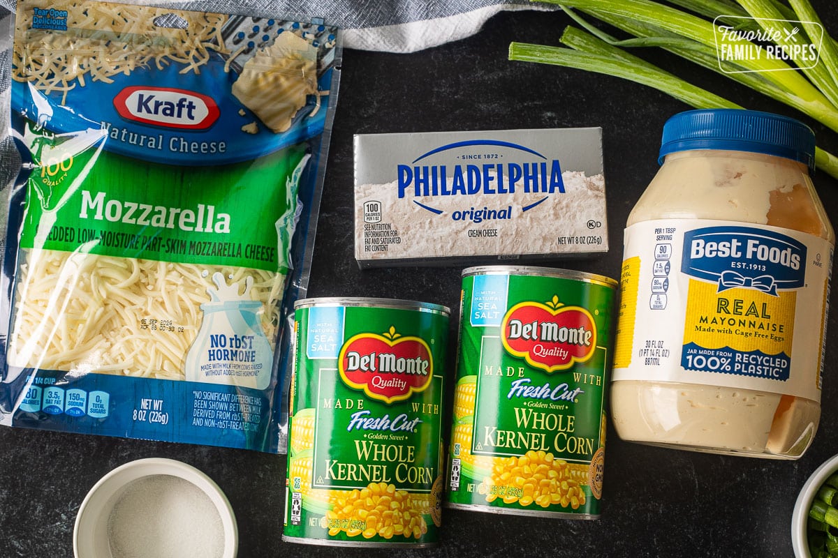 Ingredients to make Corn Cheese including mayo, whole kernel corn cans, cream cheese, mozzarella cheese, sugar and green onion.