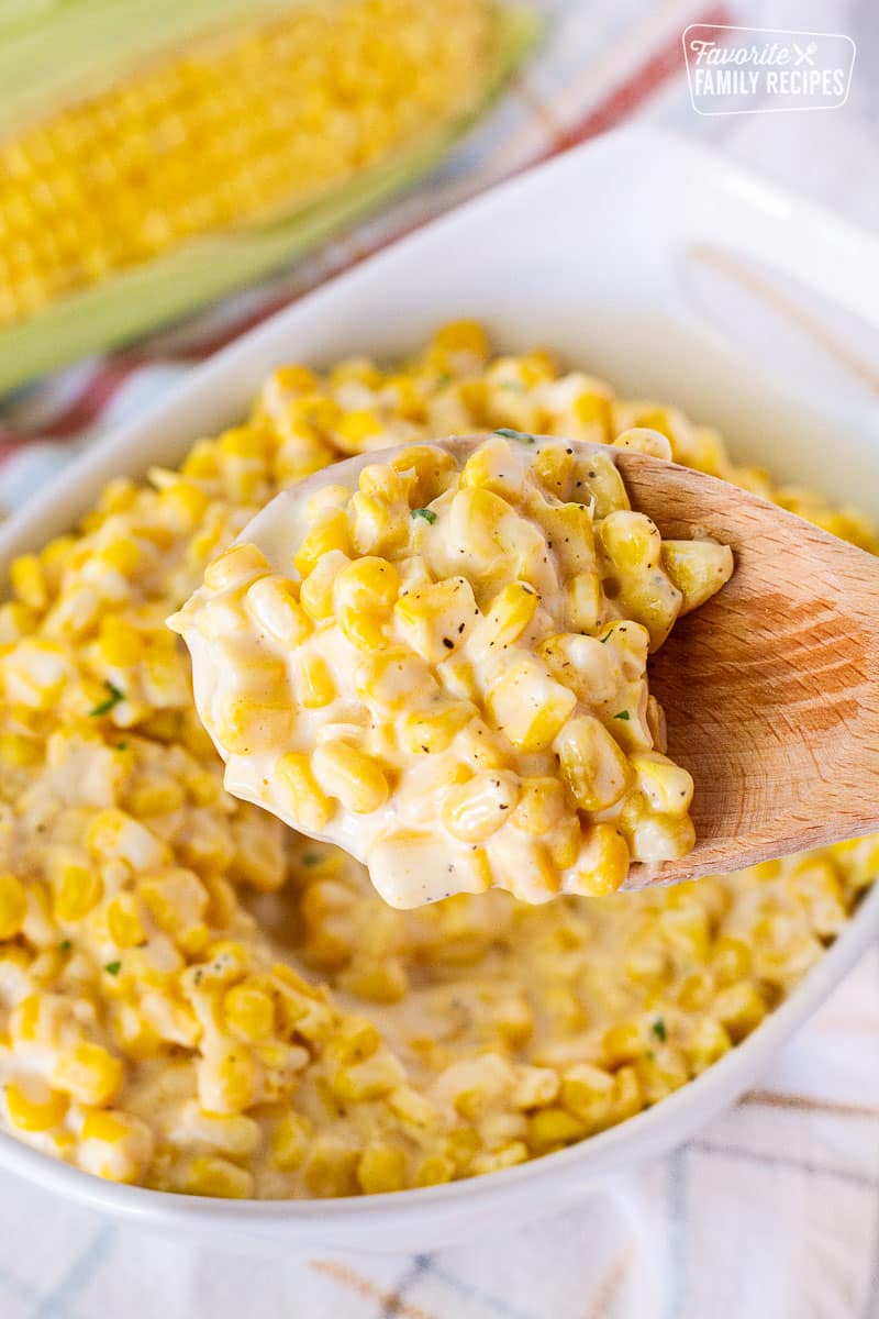 Spoon holding scoop of Creamed Corn.