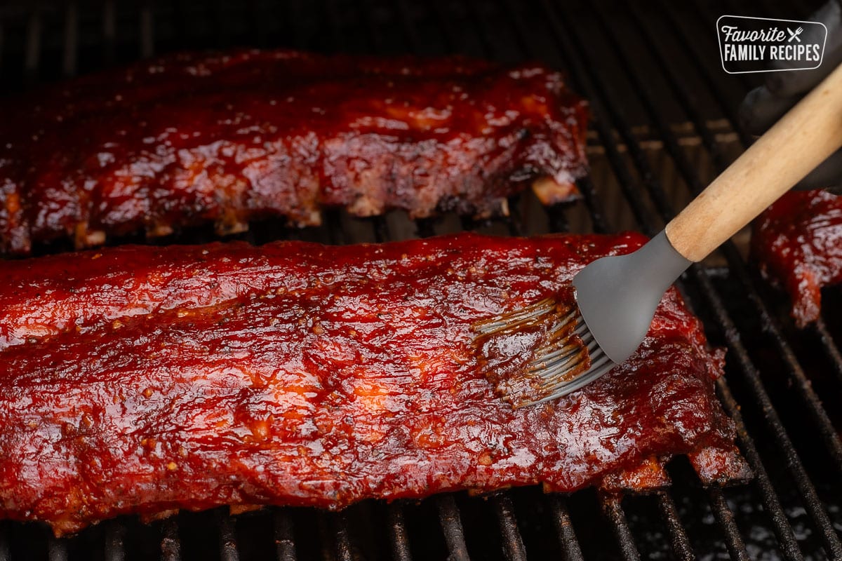 Spreading glaze on smoked ribs.