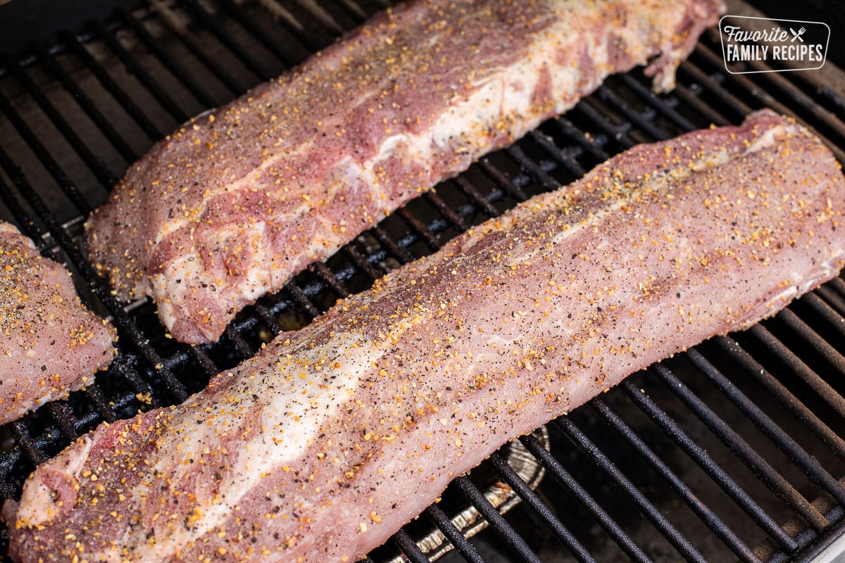 Seasoned rack of ribs on a smoker.