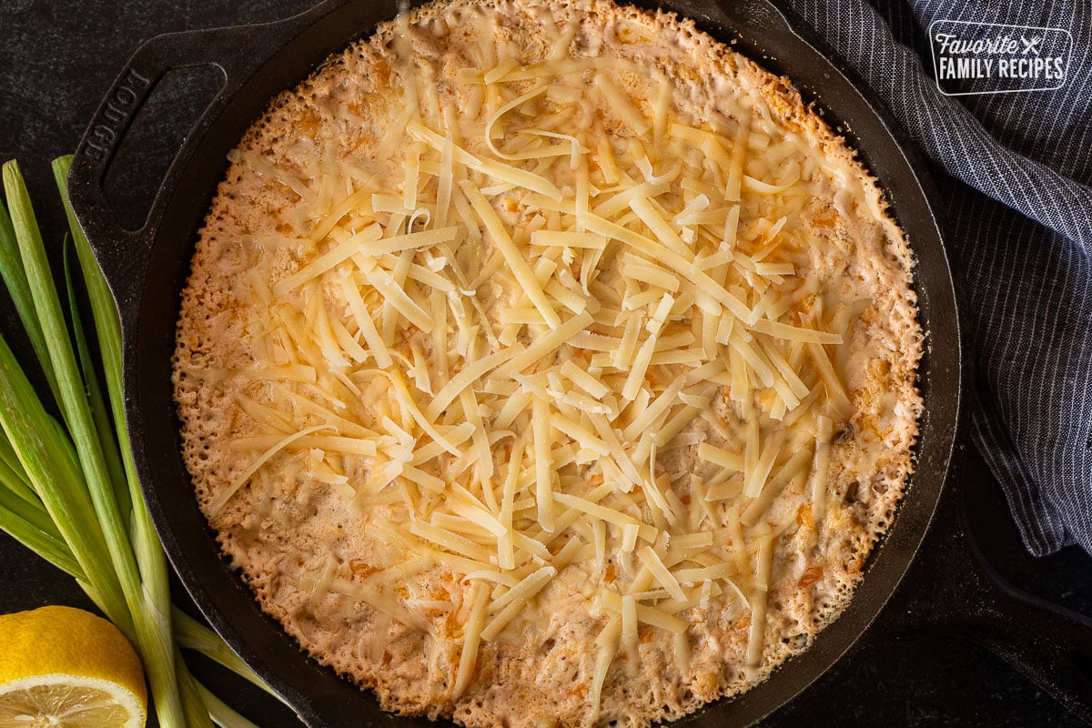 Baked hot crab dip with unmelted parmesan cheese on top.