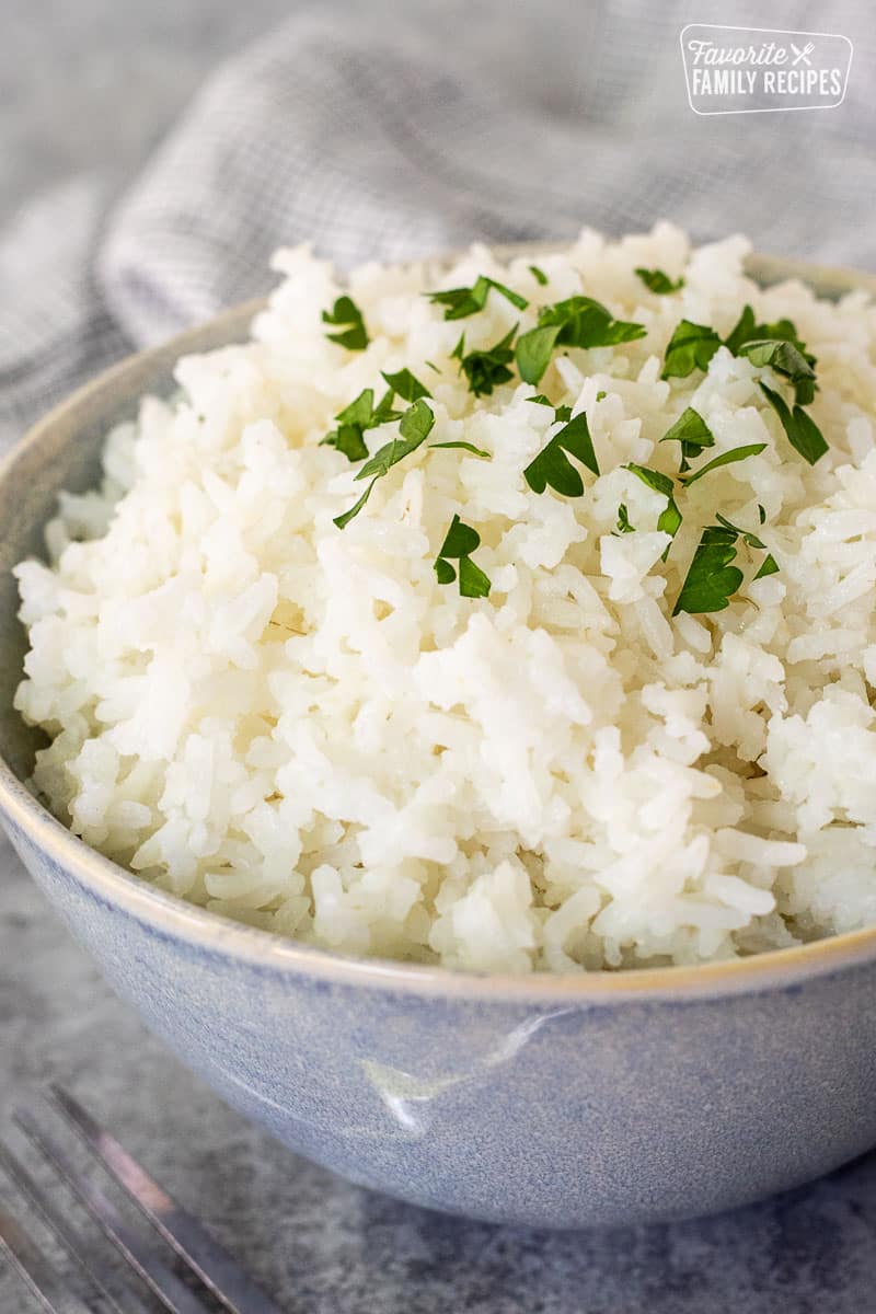 Bowl of Long Grain Rice topped with parsley for garnish.